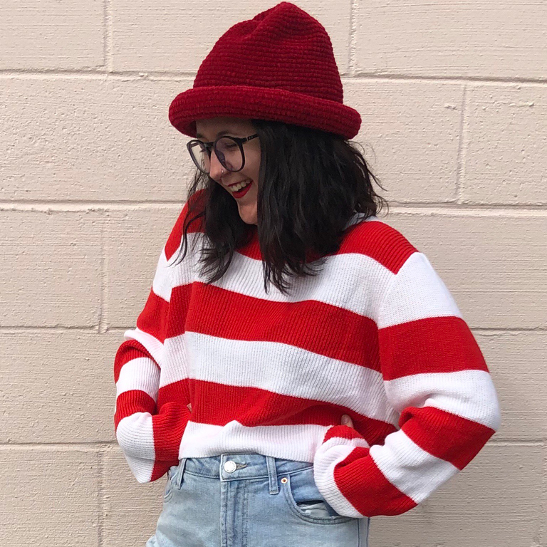 A smiling Madison Rose wearing a "Where's Waldo?" style outfit.